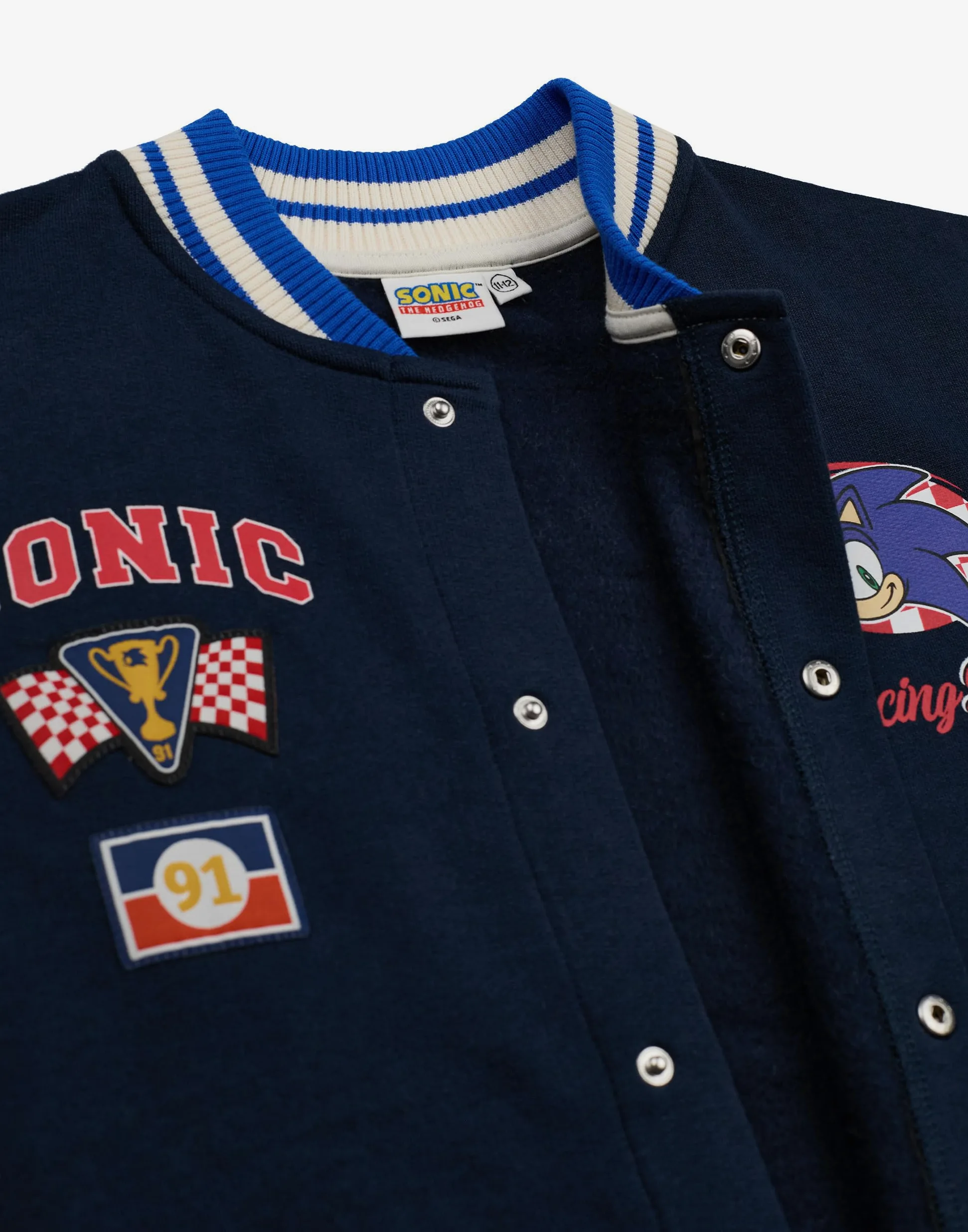 Sonic The Hedgehog Chaqueta bomber para niños| Chaqueta universitaria Sonic Racing Team para niños en Azul | Chaqueta de béisbol con cremallera y estampado de bandera a cuadros del personaje Sonic